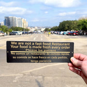 Sign - English & Spanish - We are not a fast food restaurant Please Be Patient