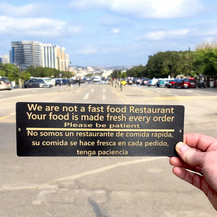 Sign - English & Spanish - We are not a fast food restaurant Please Be Patient