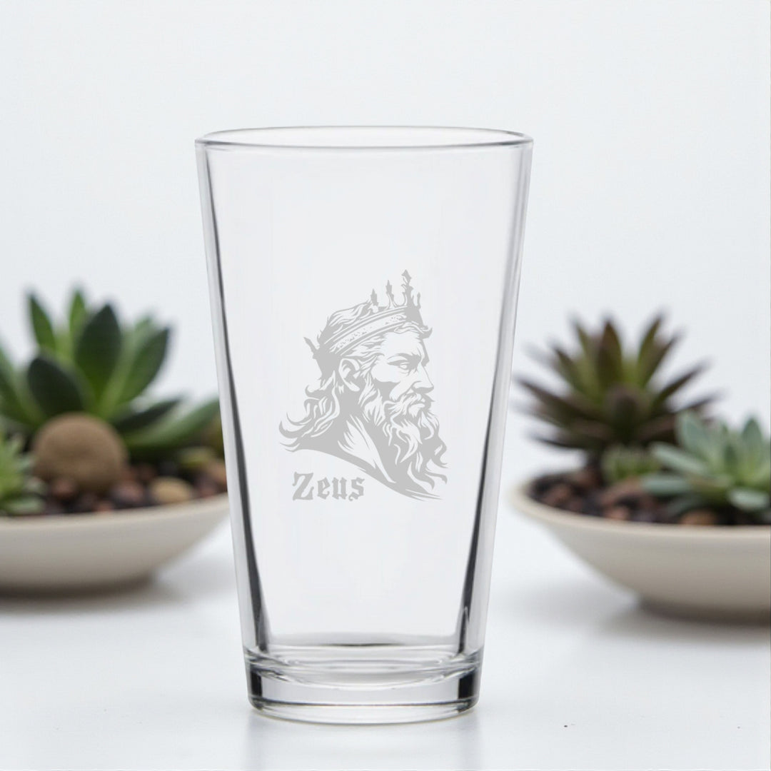 HipFlaskPlus 16oz pint beer glass engraved with Zeus God of Thunder beside succulents