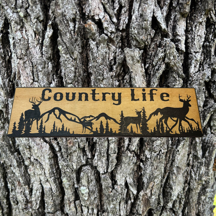 HipFlaskPlus Country Life deer mountain scene black and natural wood sign on a tree trunk