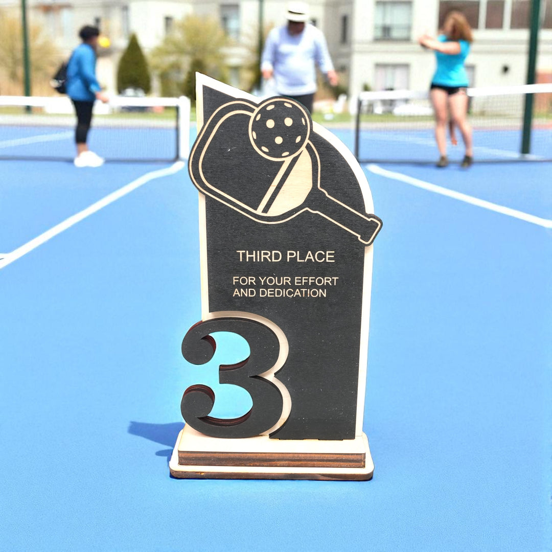 HipFlaskPlus custom Pickleball third place trophy award on a pickleball court
