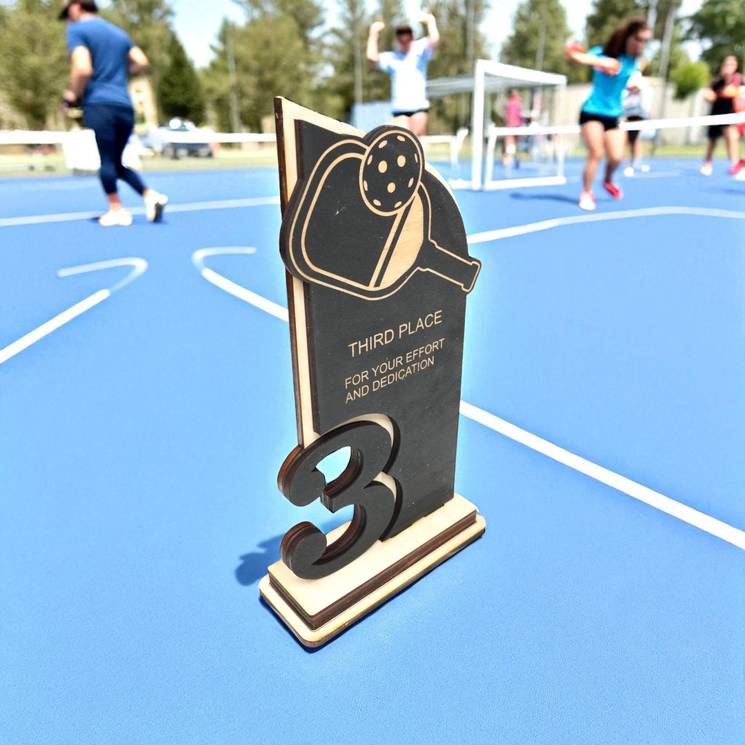 HipFlaskPlus custom Pickleball third place trophy award side view on a pickleball court