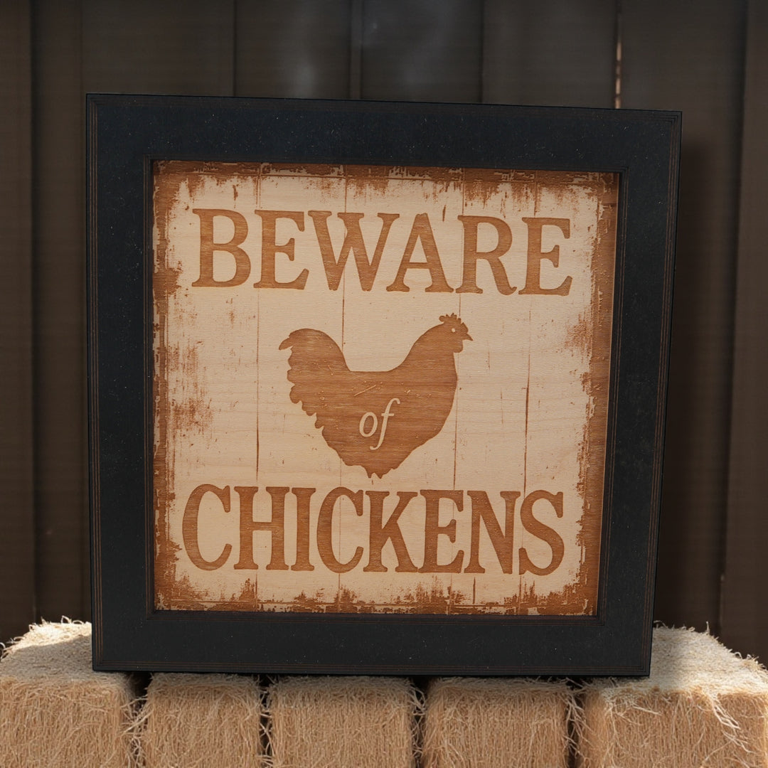 HipFlaskPlus Beware of Chickens engraved wood wall art in a black frame in a barn