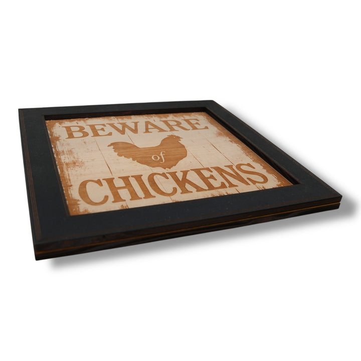 HipFlaskPlus Beware of Chickens engraved wood wall art in a black frame in an angled close-up