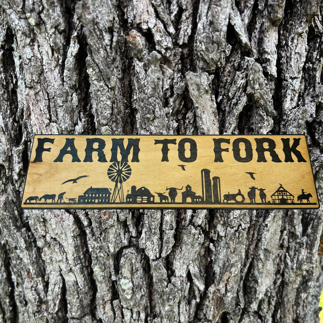 HipFlaskPlus Farm to Fork black and natural wood sign on a tree trunk