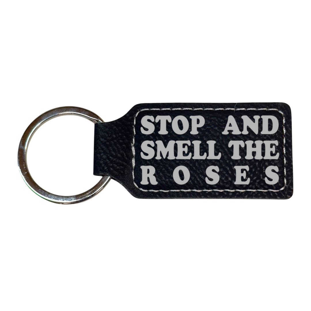 HipFlaskPlus black leather rectangle keychain with Stop and Smell the Roses engraving