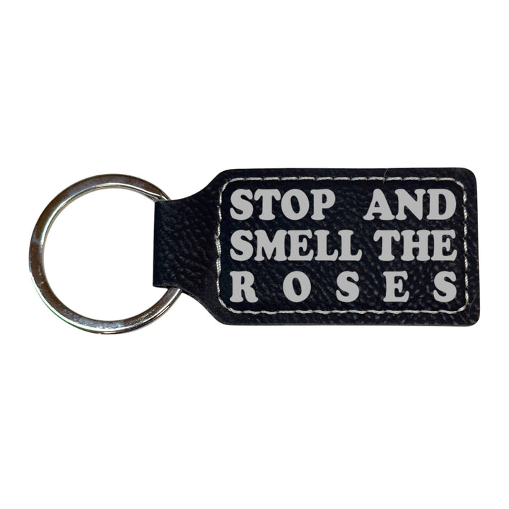 HipFlaskPlus black leather rectangle keychain with Stop and Smell the Roses engraving