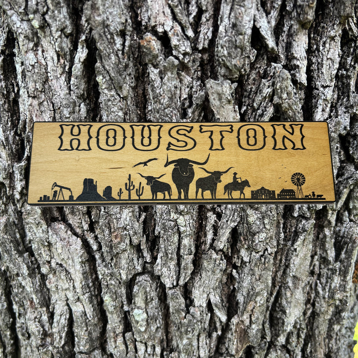HipFlaskPlus Houston landscape black and natural wood sign on a tree trunk