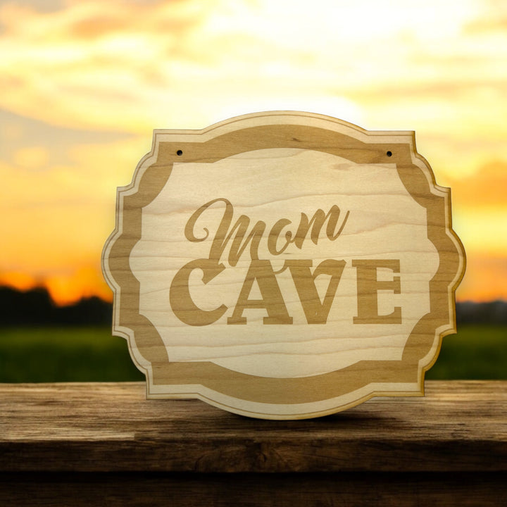 HipFlaskPlus Mom Cave raw wood door sign at sunset