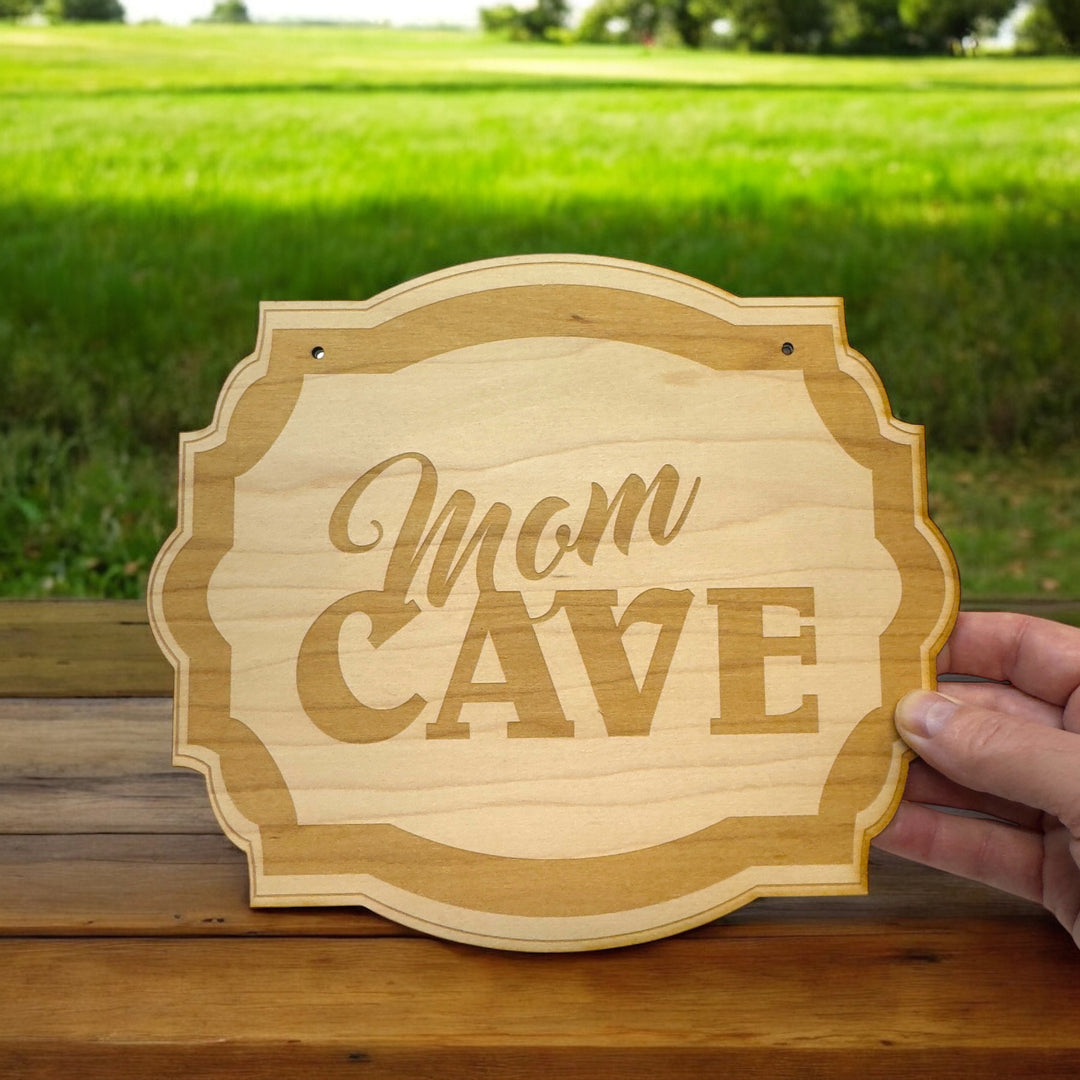 HipFlaskPlus Mom Cave raw wood door sign in a garden