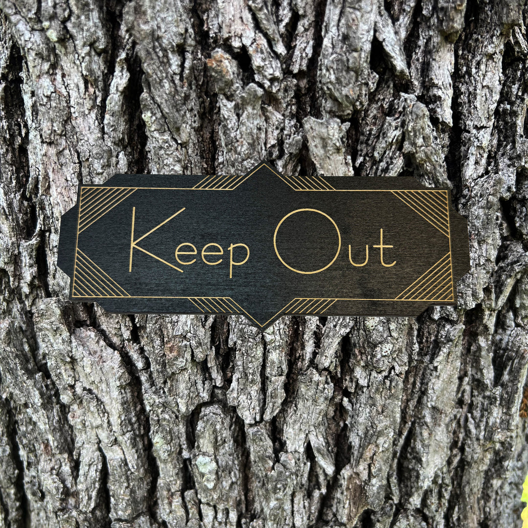 HipFlaskPlus Keep Out black art deco wood sign on a tree trunk