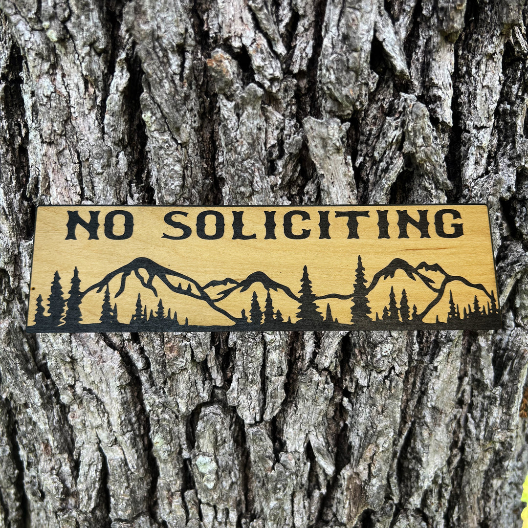 HipFlaskPlus No Soliciting mountain scene black and natural wood sign on a tree trunk