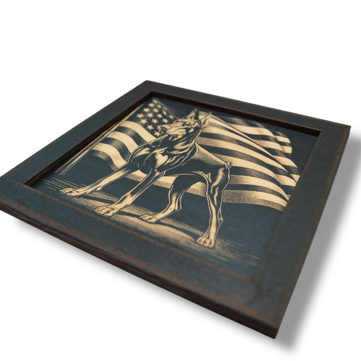 HipFlaskPlus Doberman and American flag engraved wood wall art in a black frame in an angled close-up