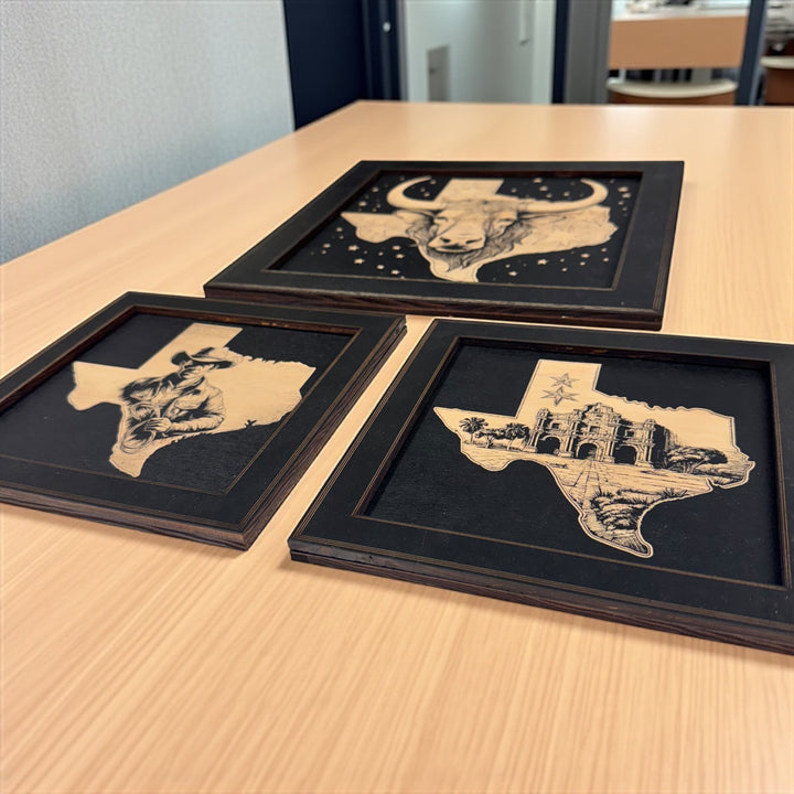 HipFlaskPlus Texas engraved wood wall art set of 3 pictures in black frames on a wooden table