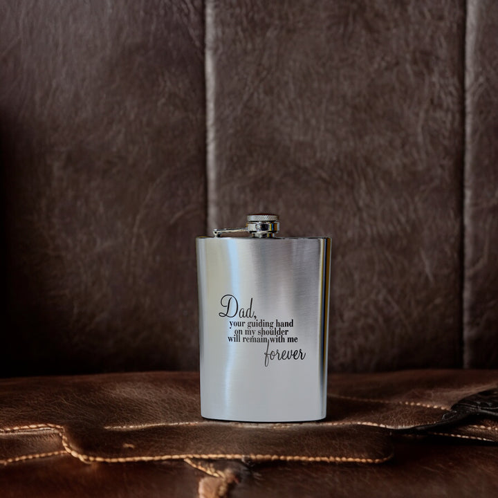 HipFlaskPlus 8oz stainless steel hip flask engraved with Dad Your Guiding Hand poem on a dark table