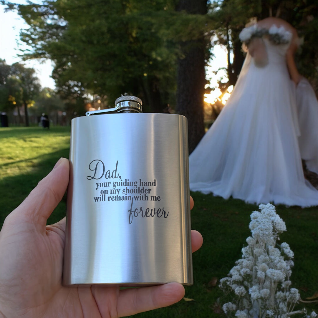 Hand holding a HipFlaskPlus 8oz stainless steel hip flask engraved with Dad Your Guiding Hand poem at a wedding