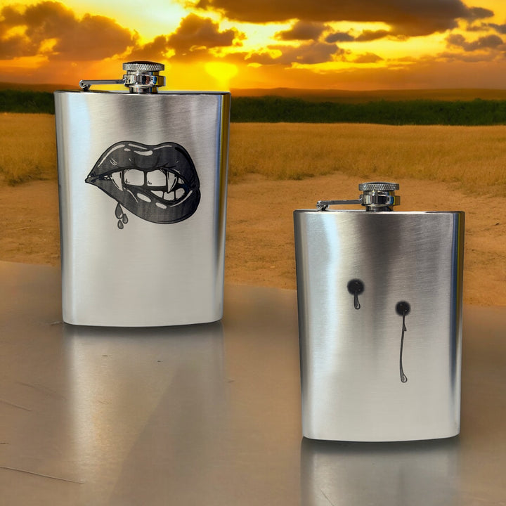HipFlaskPlus 8oz stainless steel hip flasks engraved with his and hers vampire lips and fangs set of two at sunset