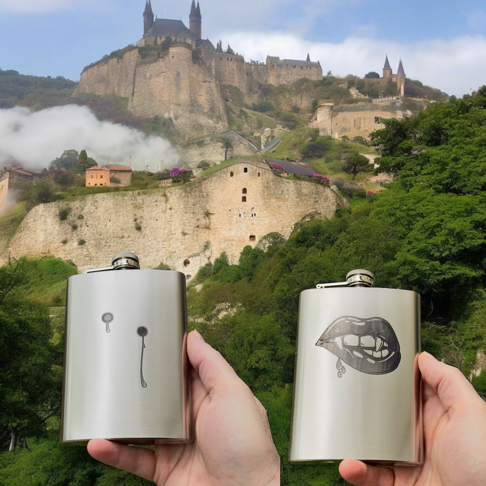 HipFlaskPlus 8oz stainless steel hip flasks engraved with his and hers vampire lips and fangs set of two by a coastal cliff
