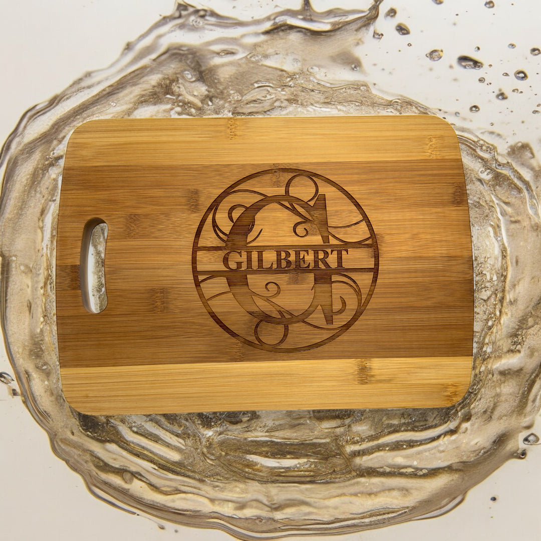 HipFlaskPlus bamboo cutting board engraved with a personalized split letter monogram and name in splashing water