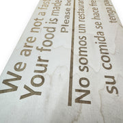 Sign - English & Spanish - We are not a fast food restaurant Please Be Patient