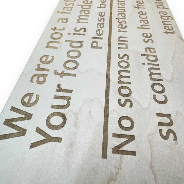 Sign - English & Spanish - We are not a fast food restaurant Please Be Patient