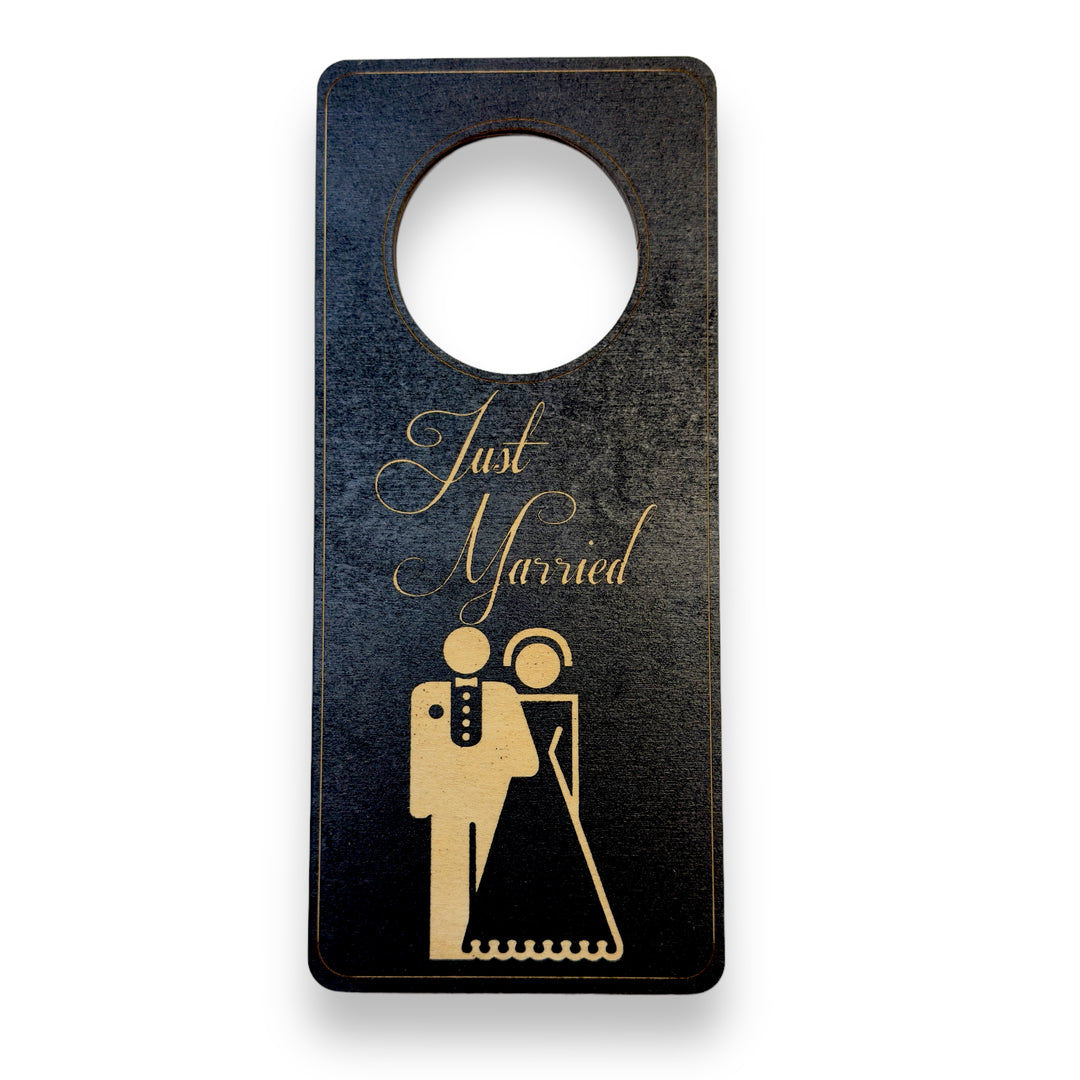 HipFlaskPlus black wood door hanger engraved with Just Married with a bride and groom
