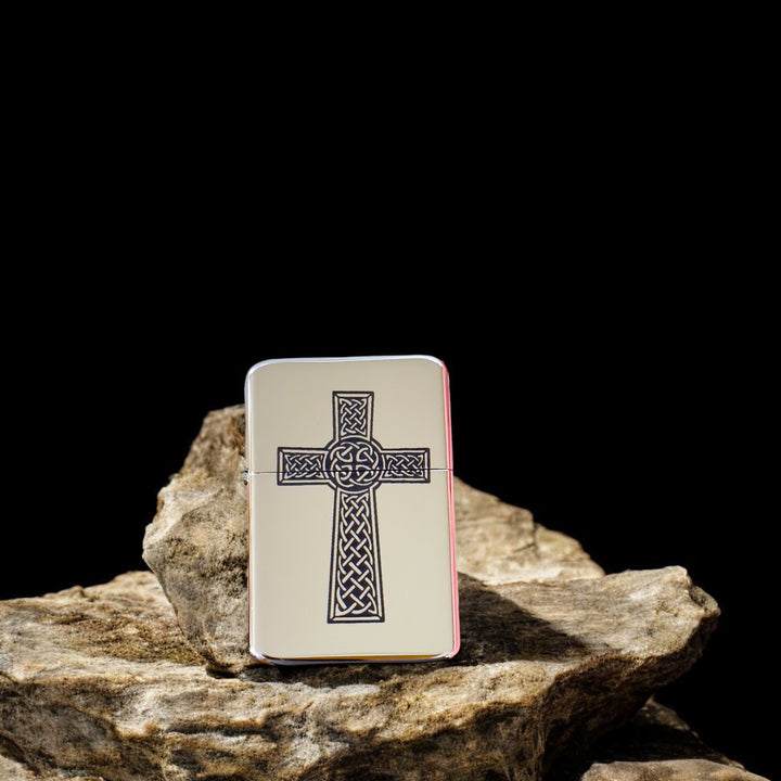 HipFlaskPlus Celtic cross chrome lighter leaning on a rock