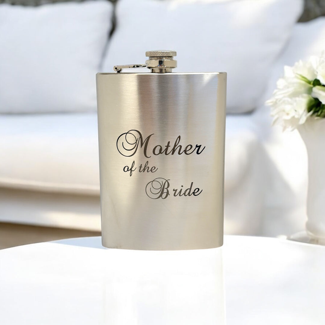 HipFlaskPlus 8oz stainless steel hip flask engraved with Mother of the Bride on a white table