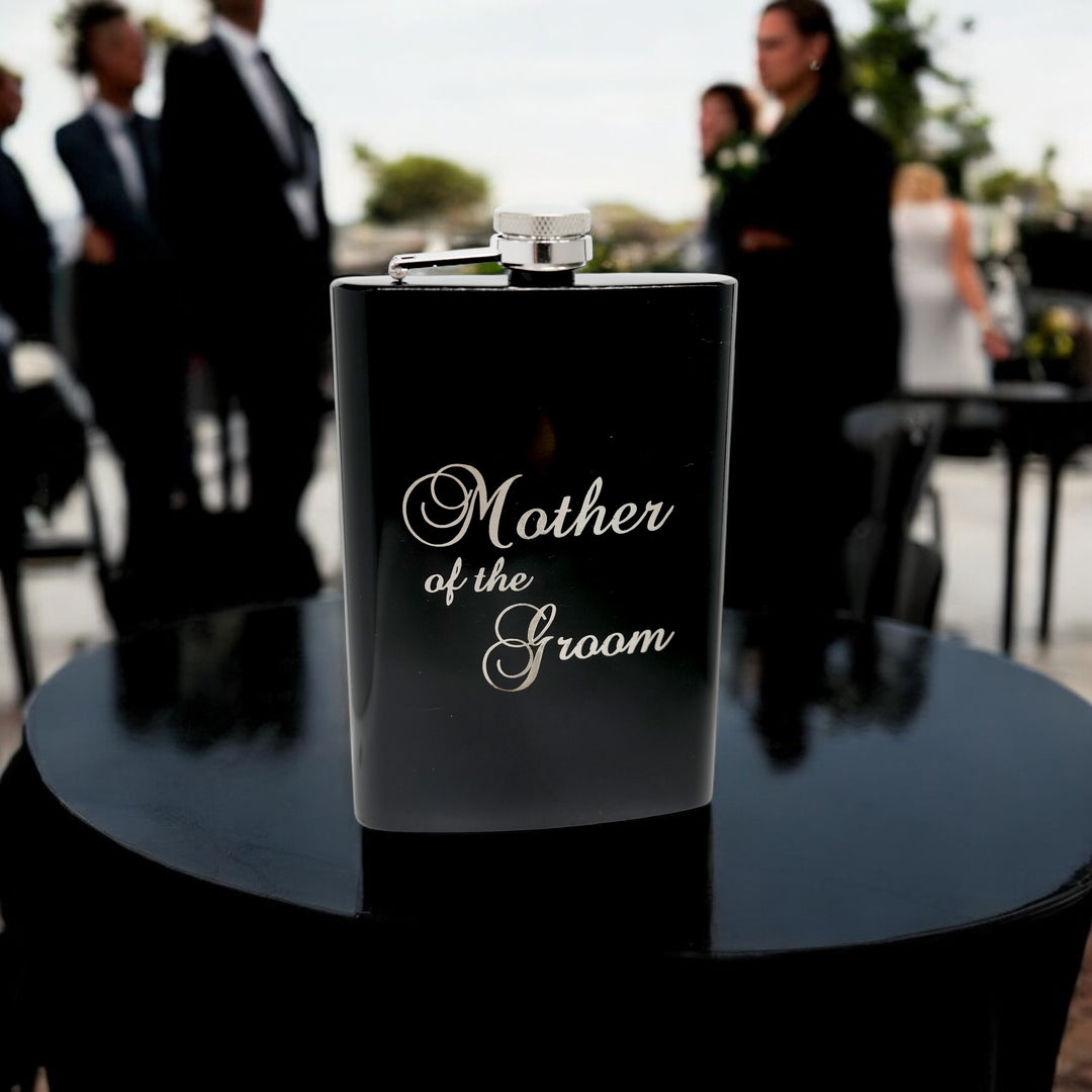 HipFlaskPlus 8oz black stainless steel hip flask engraved with Mother of the Groom at a wedding reception