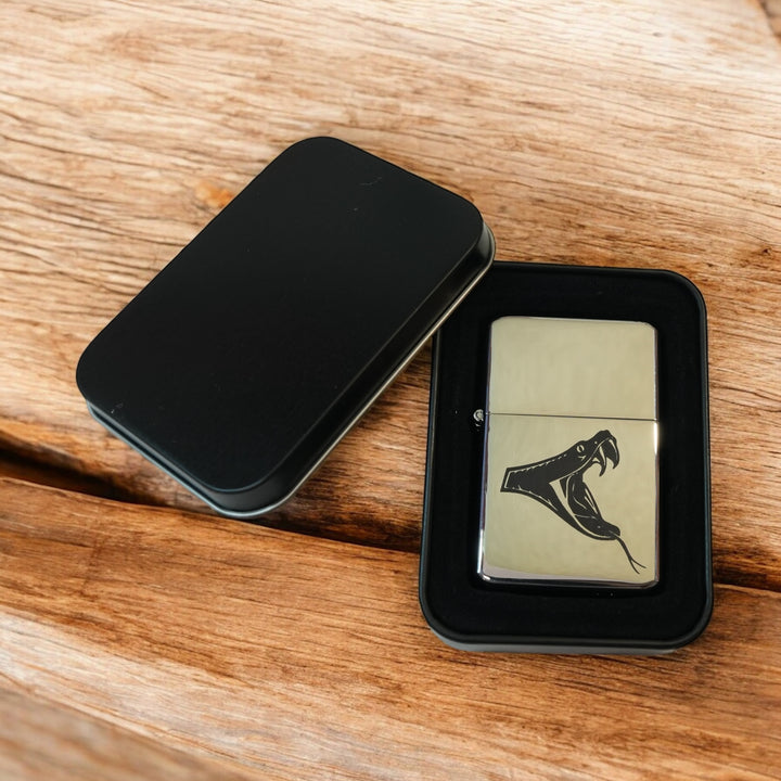 HipFlaskPlus poison viper chrome lighter in an open black gift tin on wood