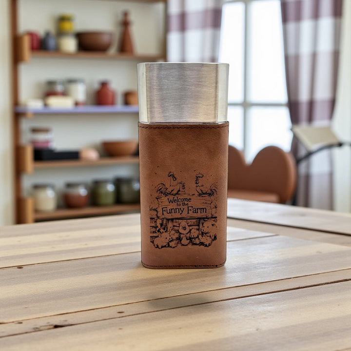 HipFlaskPlus brown leatherette cigar case with cutter engraved with Welcome to the Funny Farm on a wooden table in a kitchen