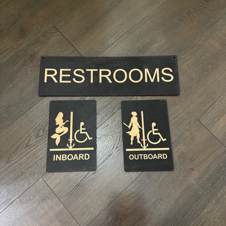 HipFlaskPlus Restrooms Inboard and Outboard black wood signs on a wood wall