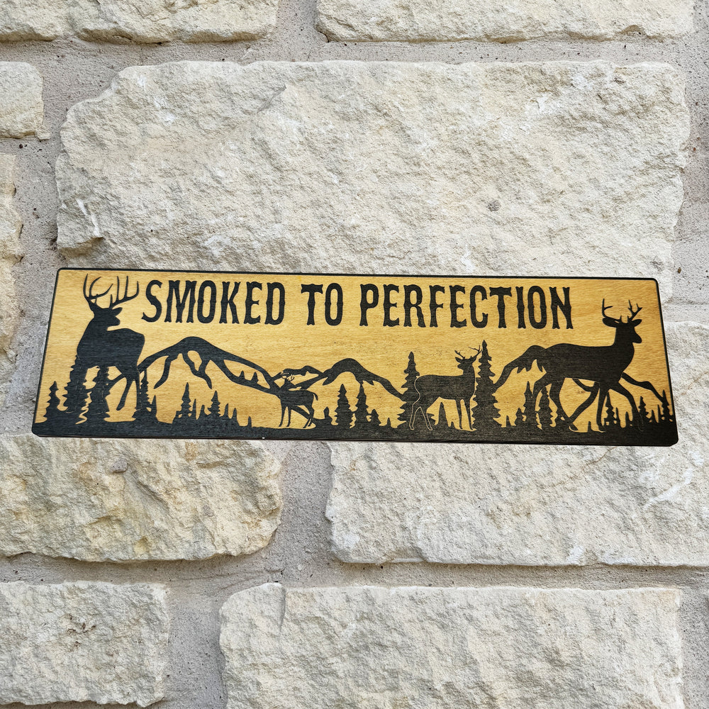 HipFlaskPlus Smoked to Perfection deer scene black and natural wood sign on a stone wall