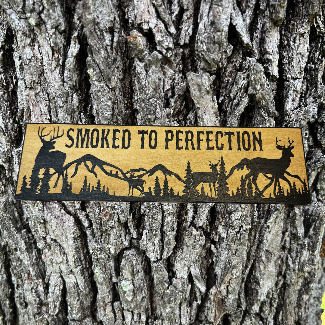 HipFlaskPlus Smoked to Perfection deer scene black and natural wood sign on a tree trunk