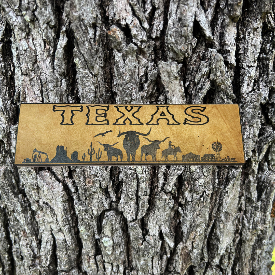 HipFlaskPlus Texas landscape black and natural wood sign on a tree trunk