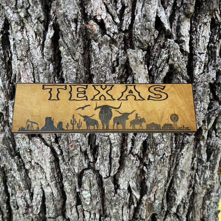 HipFlaskPlus Texas landscape black and natural wood sign on a tree trunk