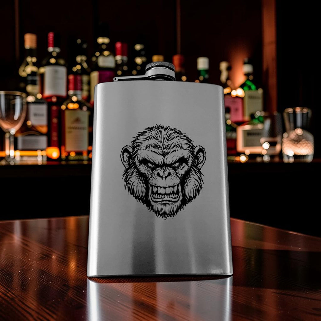 HipFlaskPlus 8oz stainless steel flask featuring a detailed Andy the Ape engraving, set on a wooden bar counter.