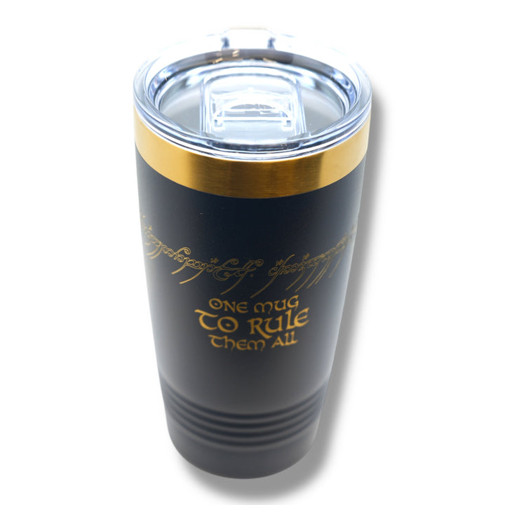 HipFlaskPlus 20oz stainless steel tumbler in black with a gold top band and laser-engraved fantasy inscription.