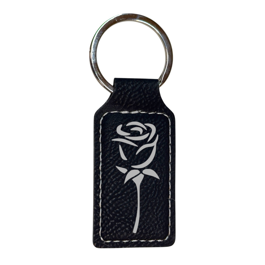HipFlaskPlus rectangular black leatherette keychain featuring a white engraved rose design and silver keyring