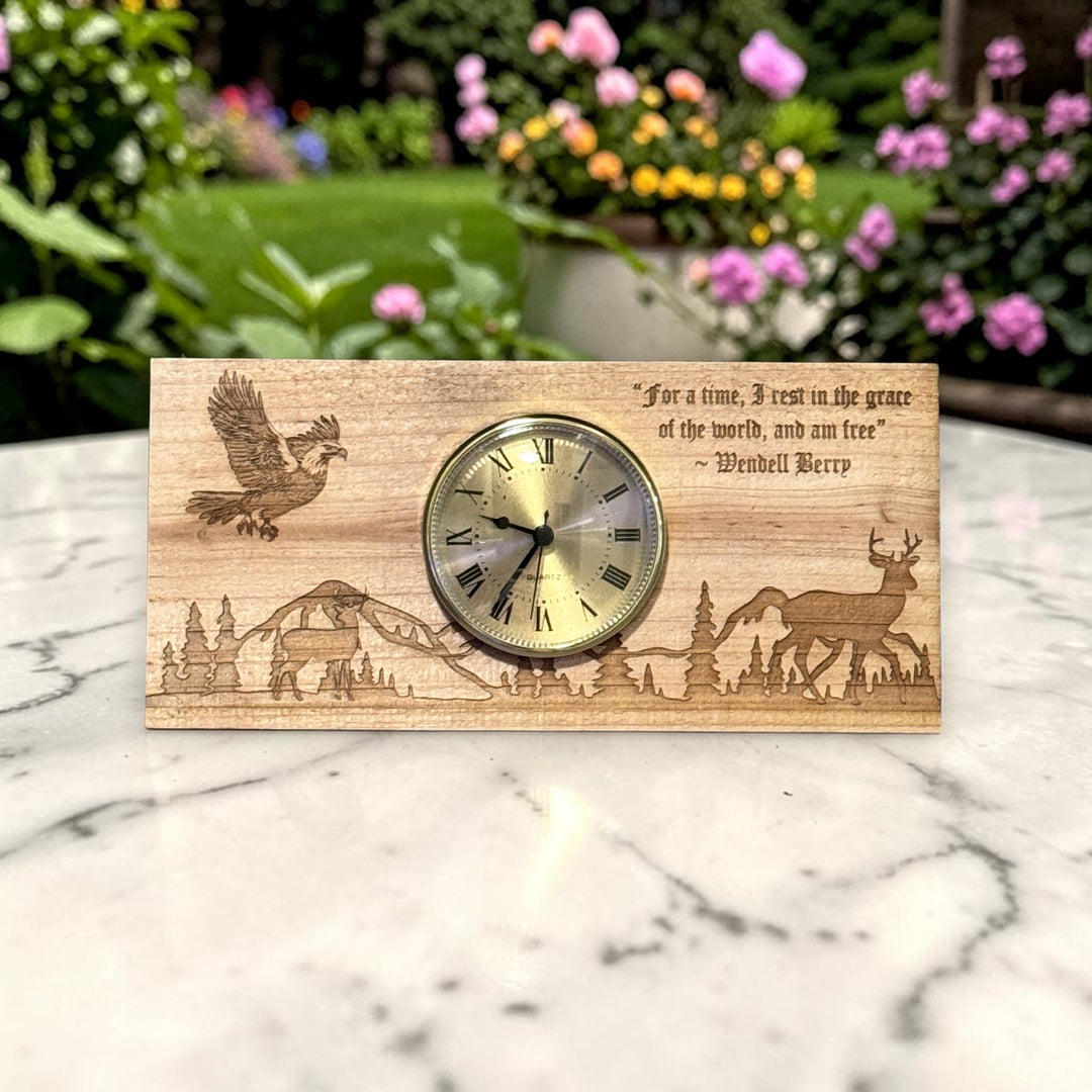 HipFlaskPlus cedar picket wooden clock with laser-engraved deer, eagle, and nature scene on a marble surface.