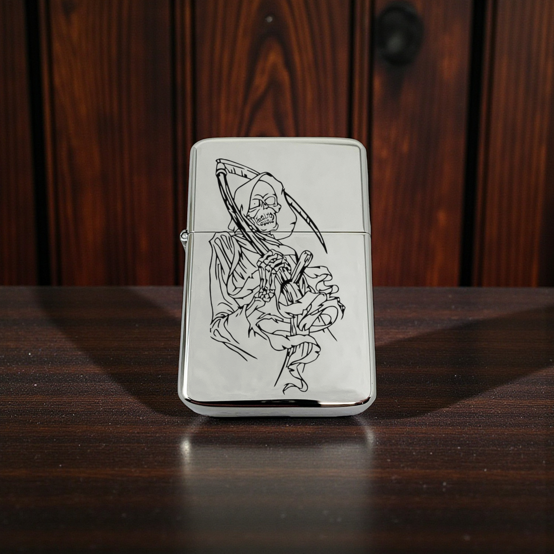 HipFlaskPlus chrome windproof lighter featuring a detailed black grim reaper dealer of death engraving on the front.