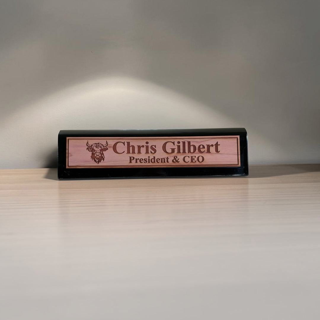 HipFlaskPlus personalized 11-inch desk wedge name plate with Highland cow engraving and black piano finish