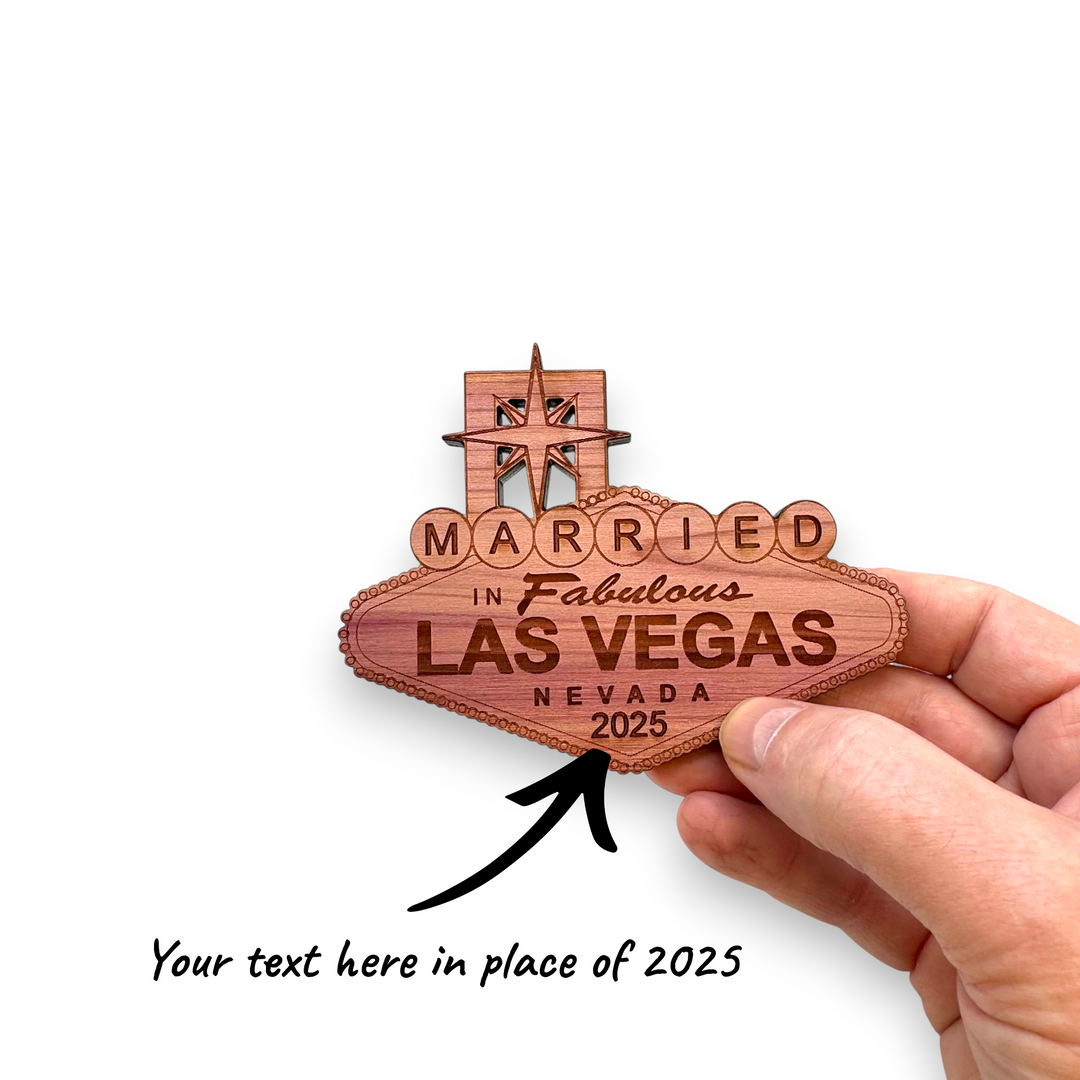 HipFlaskPlus personalized raw cedar wood ornament shaped like the iconic Las Vegas sign, held in a hand.