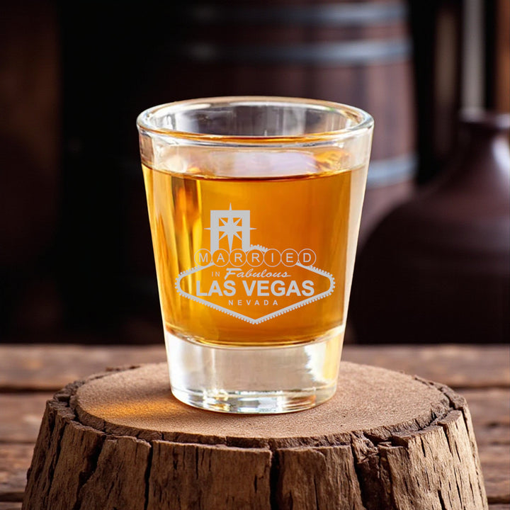 HipFlaskPlus 2oz clear glass shot glass with permanent Married in Las Vegas engraving on a rustic wood base