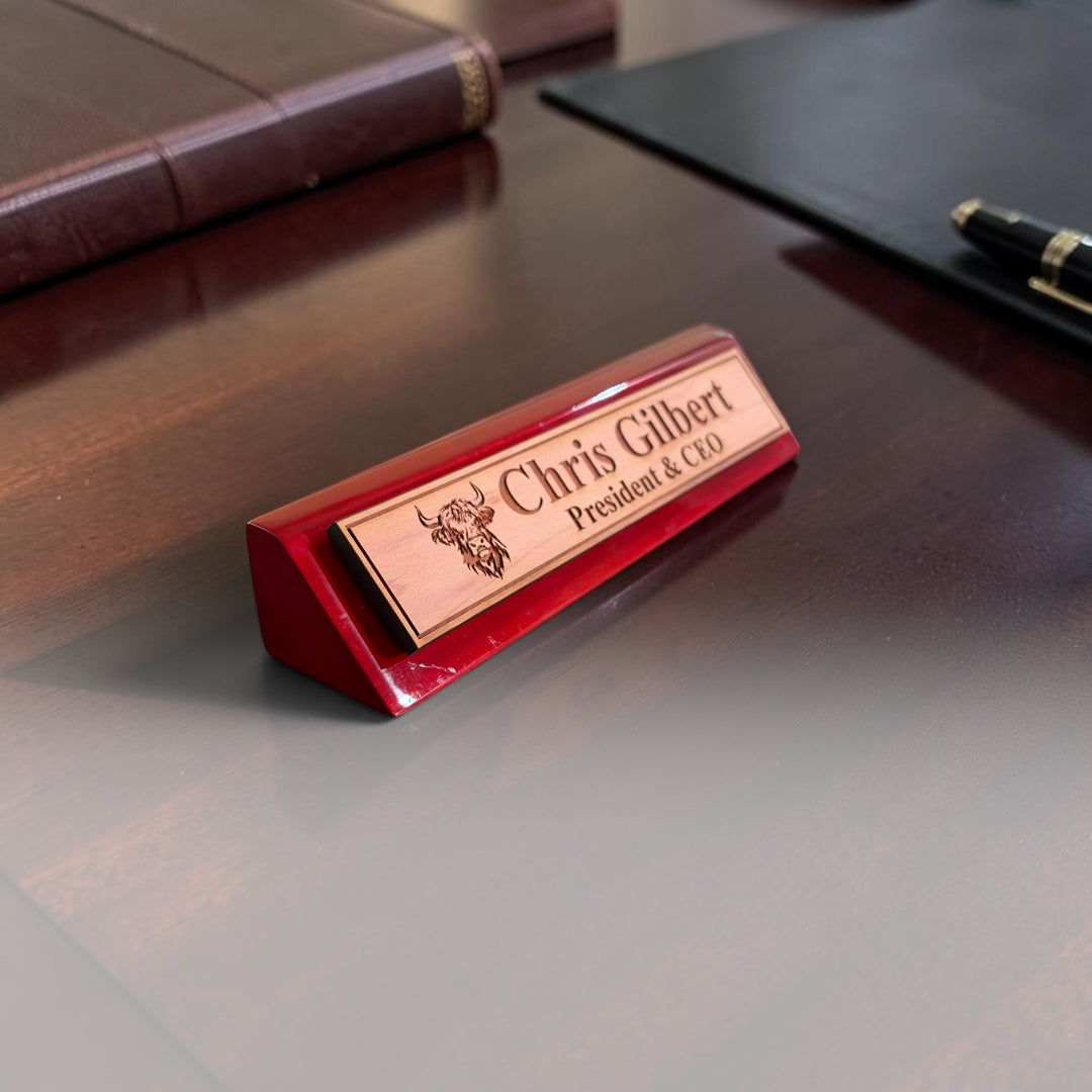 HipFlaskPlus personalized rosewood desk wedge name plate with Highland cow engraving on a dark wood office desk