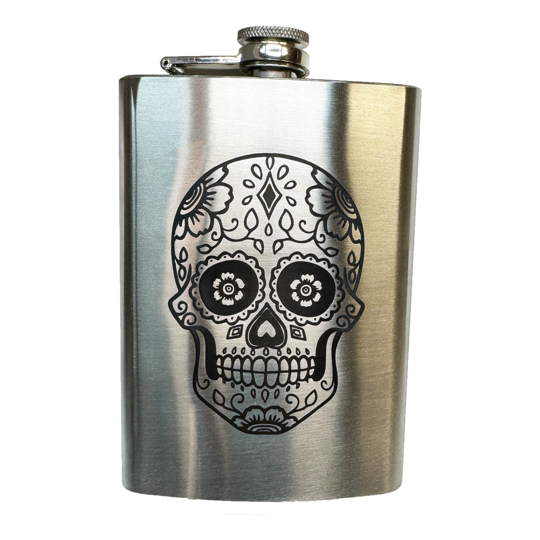 HipFlaskPlus 8oz stainless steel flask with a detailed black machine-engraved sugar skull design and screw-down cap.