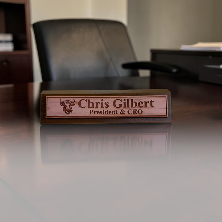 HipFlaskPlus personalized 11-inch walnut desk wedge name plate featuring a laser-engraved Highland cow design.
