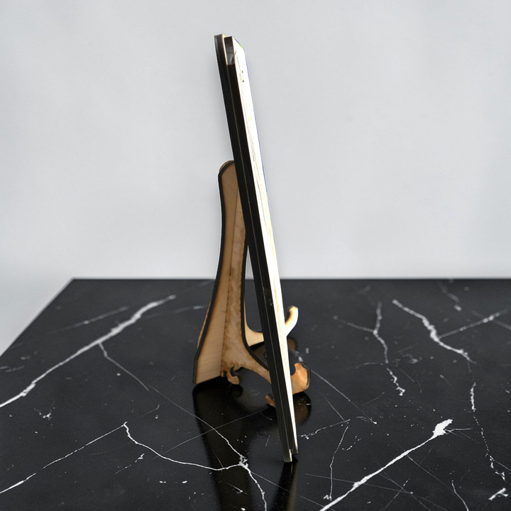 HipFlaskPlus raw wood 50 state American puzzle map kit displayed on a wooden stand on a black marble surface