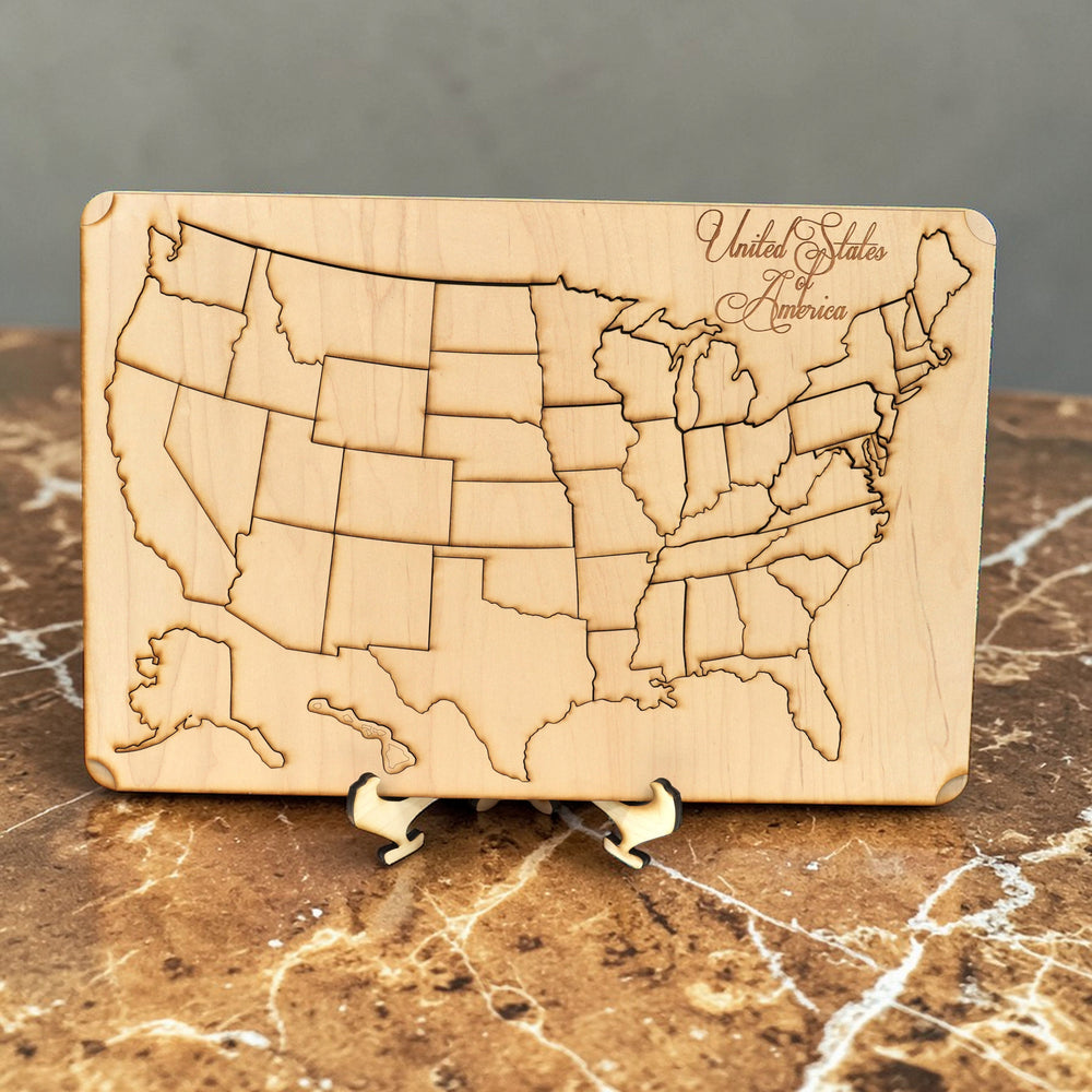 HipFlaskPlus raw wood 50 state American puzzle map art kit with display stand on a marble surface
