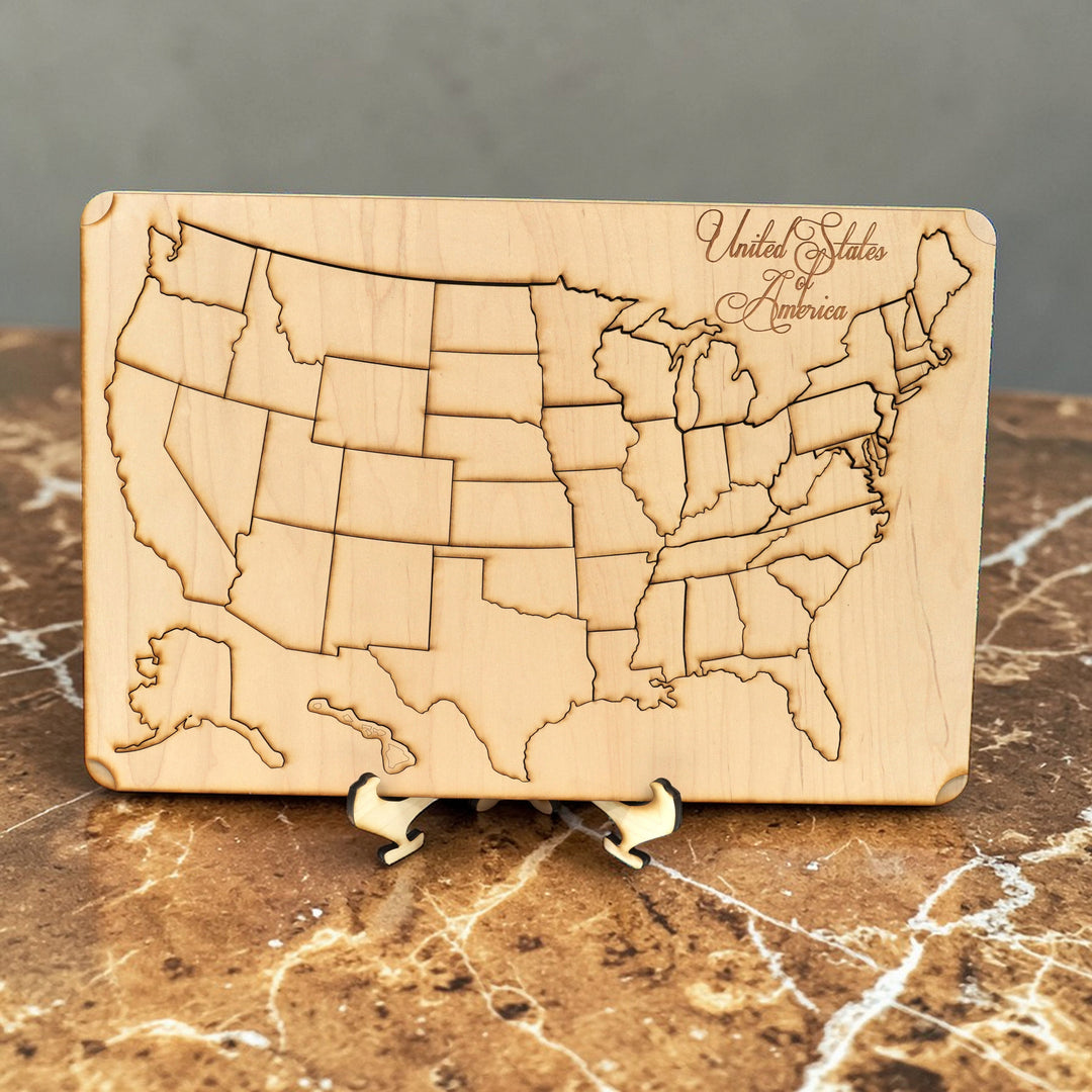 HipFlaskPlus raw wood 50 state American puzzle map art kit with display stand on a marble surface